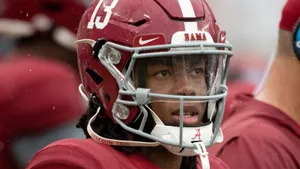 Focused Football Playerin Rain Wallpaper