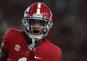 Focused Football Playerin Red Uniform Wallpaper