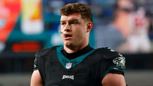 Focused Football Playeron Field Wallpaper