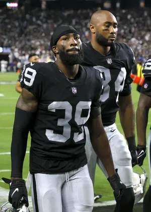 Focused Football Players Walking Off Field Wallpaper