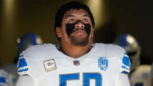 Focused Football Playerwith Captain Patch Wallpaper