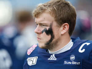 Focused Football Playerwith Eye Black Wallpaper