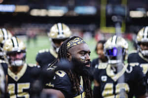 Focused Football Playerwith Team Wallpaper