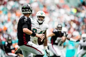 Focused Quarterback Action Dolphins Game Wallpaper