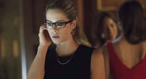 Focused Womanwith Glassesand Earrings Wallpaper