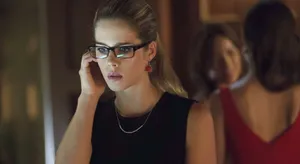 Focused Womanwith Glassesand Earrings Wallpaper