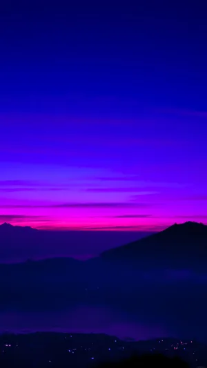Foggy Mountains On A Blue And Purple Sunset Wallpaper