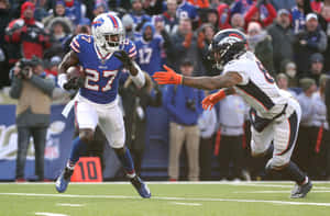 Football Action Buffalo Bills Player Evading Tackle Wallpaper