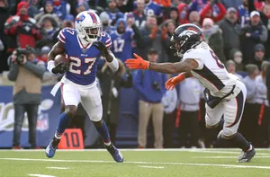 Football Action Buffalo Bills Player Evading Tackle Wallpaper