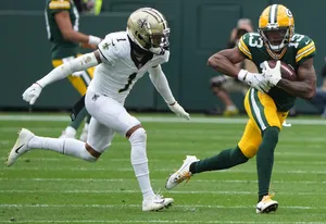 Football Action Catch Greenand White Uniforms Wallpaper