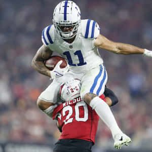 Football Athlete Evading Tackle Action Shot Wallpaper