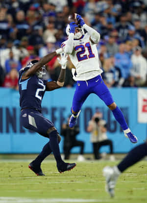 Football Athlete Mid Air Catch Wallpaper