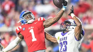 Football Athletes Competingfor Ball Wallpaper