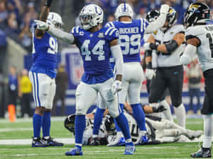 Football Linebacker Commanding Defense Wallpaper