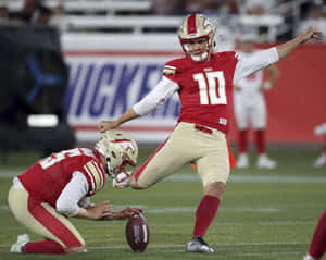 Football Placekicker Preparing For Kick Wallpaper