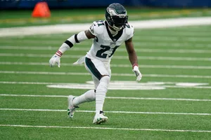 Football Player Action Shoton Field Wallpaper