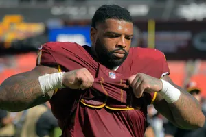 Football Player Adjusting Jersey Wallpaper