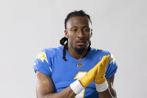 Football Player Blue Jersey Yellow Gloves Wallpaper