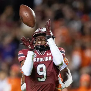 Football Player Catching Ball Action Shot Wallpaper