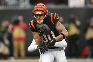 Football Player Catching Ball Action Shot Wallpaper