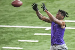 Football Player Catching Ball During Drill Wallpaper