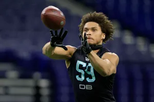 Football Player Catching Ball During Drill Wallpaper