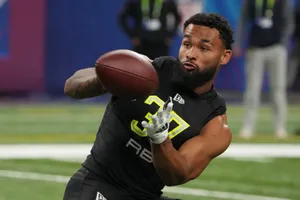 Football Player Catching Ball During Drill Wallpaper