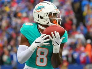 Football Player Catching Ball During Game Wallpaper