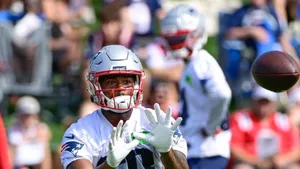 Football Player Catching Ball During Game Wallpaper