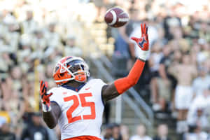 Football Player Catching Ball During Game Wallpaper