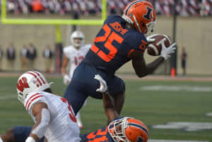 Football Player Catching Ball During Game Wallpaper