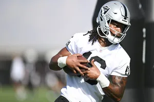 Football Player Catching Ball During Practice Wallpaper