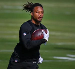 Football Player Catching Ball During Practice Wallpaper