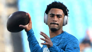 Football Player Catching Ball Headphones Wallpaper