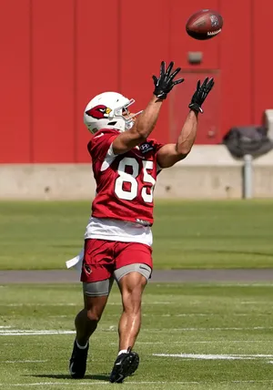 Football Player Catching Ball Practice Field Wallpaper