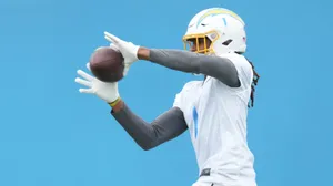 Football Player Catching Ball Practice Wallpaper