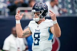 Football Player Celebrating Victory Gesture Wallpaper