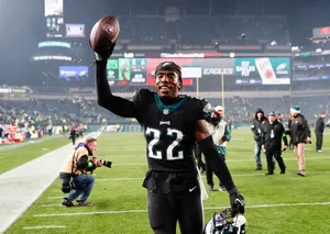 Football Player Celebrating Victory With Ball Wallpaper