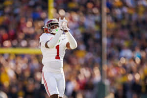 Football Player Celebratingon Field Wallpaper