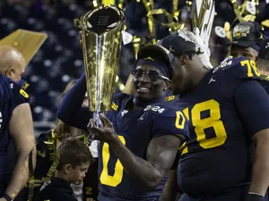 Football Player Celebratingwith Trophy Wallpaper