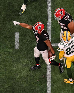 Football Player Celebrationon Field Wallpaper