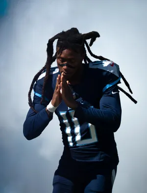 Football Player Contemplative Pose Wallpaper