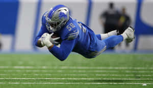 Football Player Diving Catch Wallpaper
