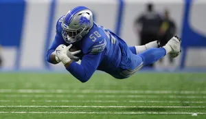 Football Player Diving Catch Wallpaper