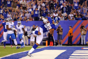 Football Player Diving Touchdown Catch Wallpaper