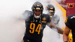 Football Player Entering Field Through Smoke Wallpaper