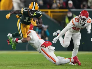 Football Player Evading Tackle Wallpaper