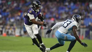 Football Player Evading Tackle Wallpaper