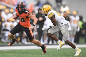 Football Player Evading Tackle Wallpaper