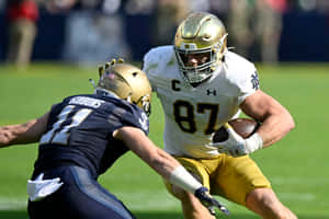 Football Player Evading Tackle Wallpaper